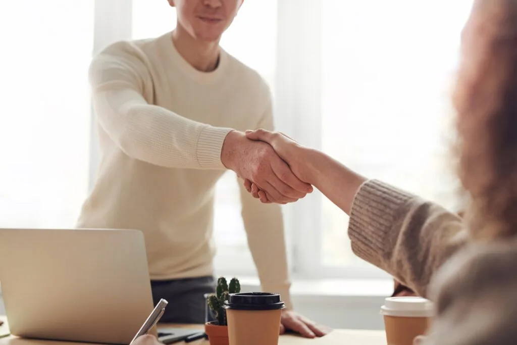 people shaking hands in an office at work